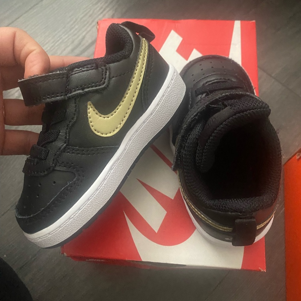 Black, white and gold toddler Nikes size 5c.
